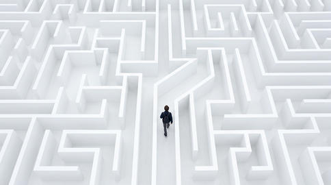Person navigating a white maze or labyrinth symbolizing strategy, problem solving and business