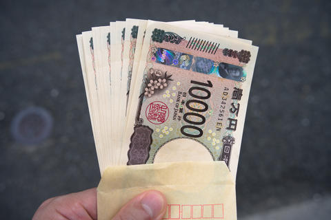 Japanese 10,000 Yen Banknotes Taken from an Envelope