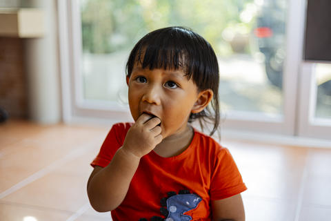 Little Boy Putting His Fingers In His Mouth