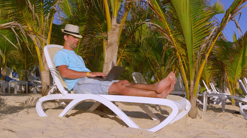 Businessman at vacation working on beach with a laptop