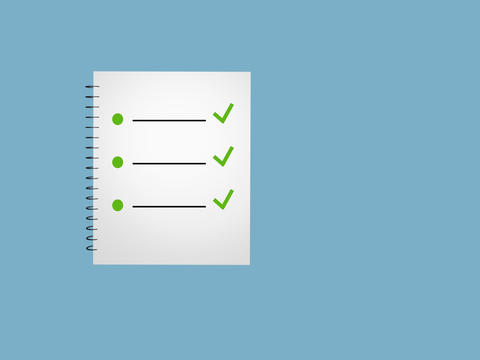 To do list and ticks on spiral notepad blue background