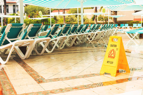 Empty hotel swimming pool area after rain