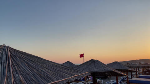 Red attention flag on beach sea ocean, complete ban on swim due to life danger