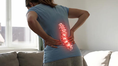 Woman feeling lower back pain with a glowing spine X-ray animation. Medical, health, and anatomy con