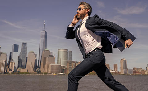 Successful businessman hurrying on New York city skyline. Business man in Manhattan. Business
