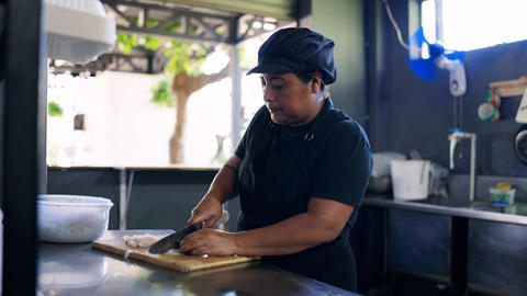 Latina cook preparing food in a local grill kitchen