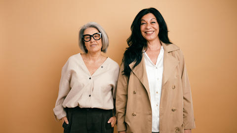 Two mature women smiling together showing friendship