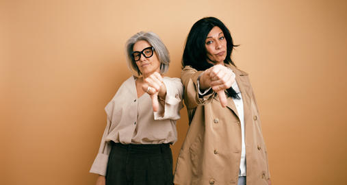 Women showing thumbs down expressing disapproval