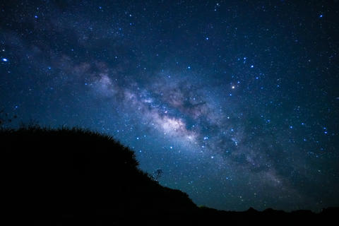 Magnificent Milky Way galaxy over rocky coast of Miyakojima, horizontal view