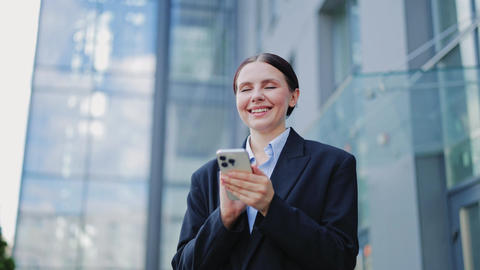 Smiling Professional Engaged With Smartphone Outdoors