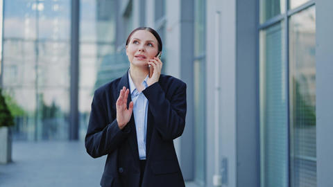 Joyful Businesswoman Conversing on Smartphone