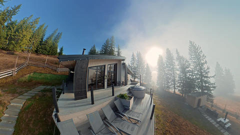 Modern mountain cabin with terrace and hot tub in morning fog, Elevated scenic view of a quiet