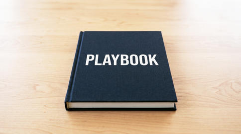 Playbook guideline or rule book on desk for business strategy planning and corporate success