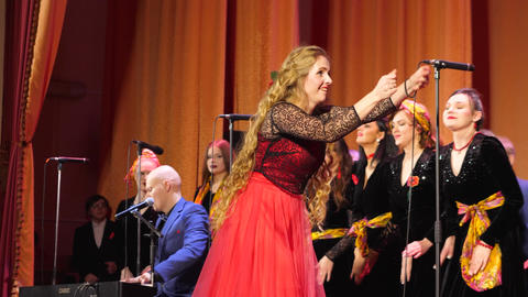 Gomel, Belarus - 11.25.2022: female conductor conducts an unseen choir