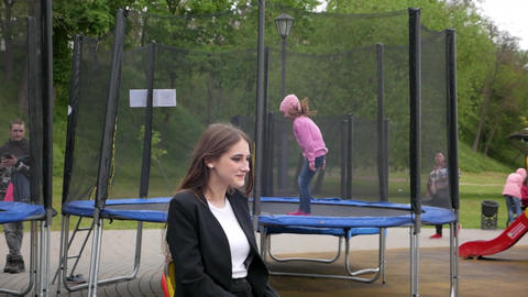 Gomel, Belarus - 05.23.2022: A smiling teenage girl rides a seesaw