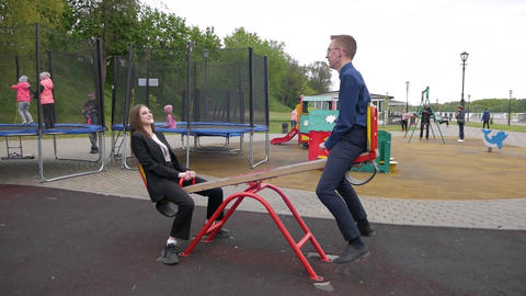 Gomel, Belarus - 05.23.2022: Teenage Couple Balancing On Seesaw At Playground