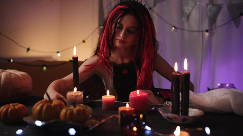 Cute Little Girl In Halloween Witch Wig Playing With Candles