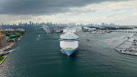 Aerial drone view of luxury liner. Ship leaving Miami beach port. Cruise ship vacation, 4k. Aerial