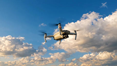 Professional Drone Flying Through Blue Sky