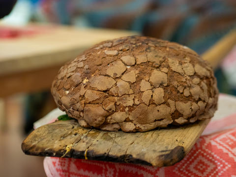 Round Crusty Sourdough Bread Loaf on Wooden Peel