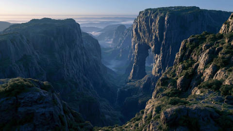 Panoramic view of a mountain valley surrounded by clouds.04