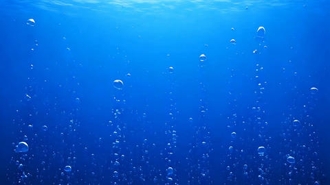 水面から差し込む光と気泡が美しい青い海の水中背景