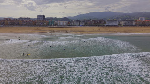 Aerial view of surfers waiting in ocean waves