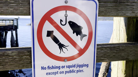 No fishing or squid jigging sign on pier
