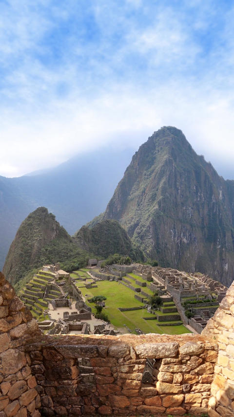 Machu Picchu Through Ancient Stone Walls - Vertical View