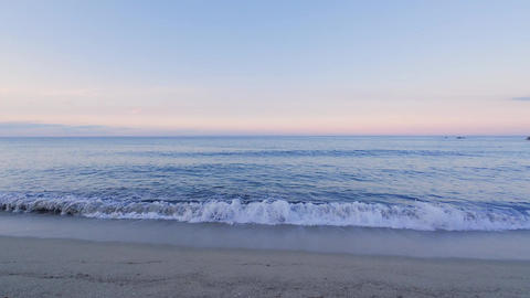 Peaceful Beach and Gentle Ocean Waves at Sunset