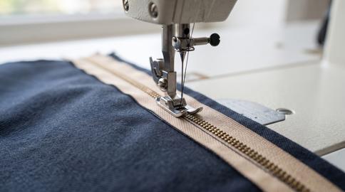 Sewing Machine Stitching Zipper into Denim Fabric Closeup Tailoring Process