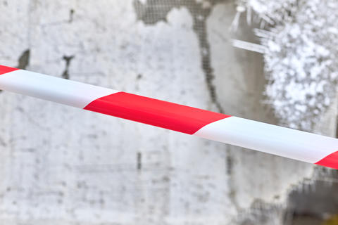 Construction fenced red tape.Old insulation material from walls