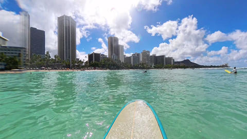 Watching Waikiki and Diamond Head while waiting for waves at Waikiki Beach