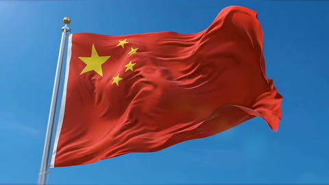 Chinese Red Flag with Yellow Star Waving on Tall Flagpole On Blue Sky for National Pride Patriotism