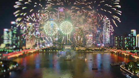 Colorful Fireworks Over Modern City Skyline Riverfront During Nighttime Holiday Celebration Event