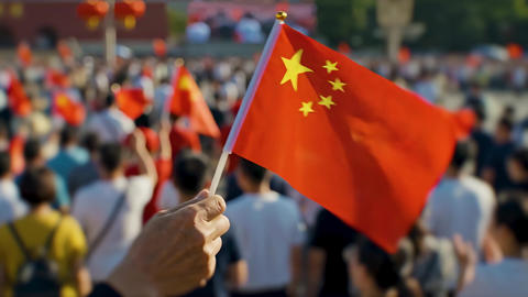 Hand Holding Chinese Flag Above Crowd During China National Day Celebration and National Pride