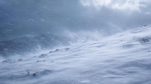 Severe Snowstorm and Strong Wind Blowing Across Frozen Mountain Slope