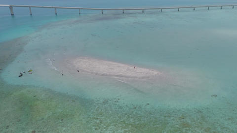 Drone orbiting Yuni no Hama beach in Miyakojima, Okinawa under cloudy summer skies
