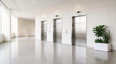 Modern hospital elevator lobby in bright medical clinic hallway