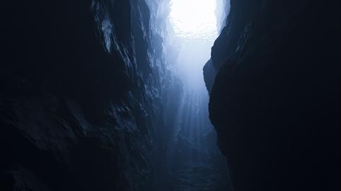 Dark Underwater Canyon with Dramatic Sun Rays and Deep Ocean Rock Walls