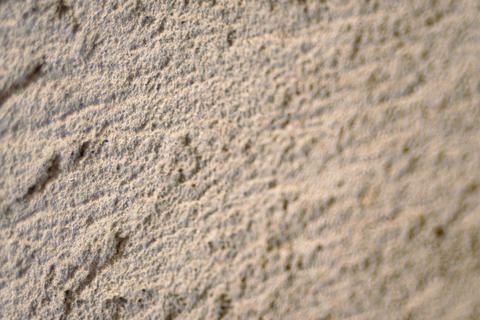 Grey concrete wall texture with rough surface details creating an abstract background