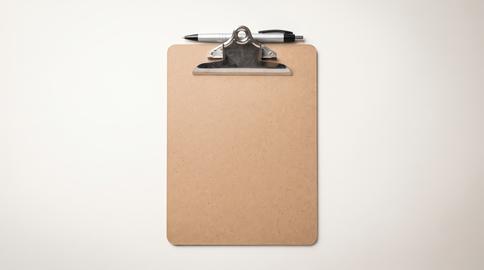 Blank medical clipboard with pen on desk in doctor clinic