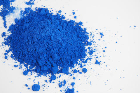 Bright blue powder on white surface