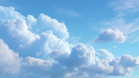 Vast blue sky filled with fluffy white cumulus clouds on a clear day