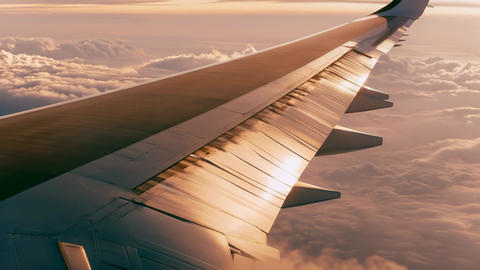 Airplane Wing Flying Above the Sea of Clouds at Sunset Footage