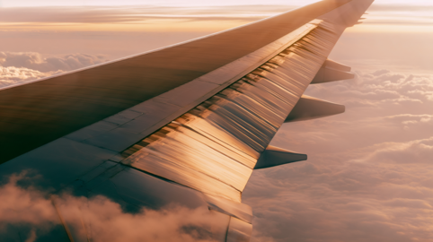 Airplane Wing Flying Above the Sea of Clouds at Sunset Footage