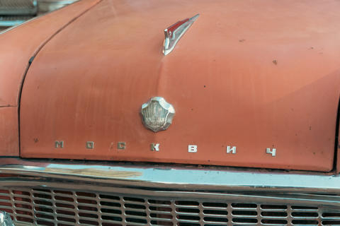 Gomel, Belarus - 08.08.2026: Vintage red car hood with chrome emblem and hood ornament