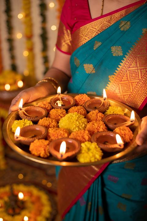 Woman Holding Traditional Diya Plate for Diwali Festival Celebration