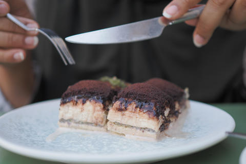 a slice of tiramisu dessert served on a white plate
