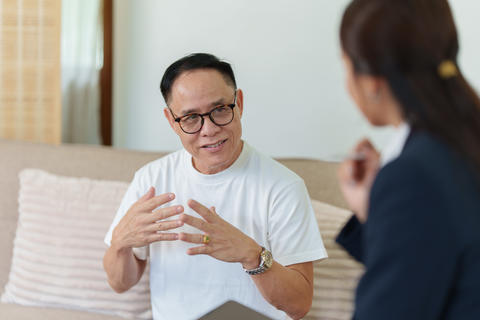 Senior Asian man talking with financial advisor at home for retirement planning